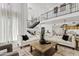Spacious living room with soaring ceilings, an open staircase, and an open floor plan to the kitchen at 7409 E Pleasant Run, Scottsdale, AZ 85258