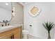 Stylish powder room with a wood vanity, a unique gold accent, and modern fixtures at 7409 E Pleasant Run, Scottsdale, AZ 85258
