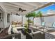 Spacious back patio area with an outdoor seating area, lounge chairs and ceiling fans at 7632 E Bonita Dr, Scottsdale, AZ 85250