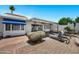 Charming backyard with brick patio, blue awning and lounge chairs at 7632 E Bonita Dr, Scottsdale, AZ 85250