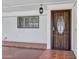 A well lit doorway with secure door, tile flooring, with an adjacent window at 7632 E Bonita Dr, Scottsdale, AZ 85250