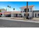 A two-story home with a covered carport, decorative iron balcony, and landscaped front yard at 7632 E Bonita Dr, Scottsdale, AZ 85250