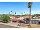 A two-story house with a red tile roof, carport, palm trees, and desert landscaping at 7632 E Bonita Dr, Scottsdale, AZ 85250