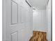Hallway with closet doors and featuring laminate wood flooring and freshly painted white walls at 7632 E Bonita Dr, Scottsdale, AZ 85250