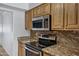 Kitchen boasts stainless steel appliances, granite countertops, and wood cabinetry at 7632 E Bonita Dr, Scottsdale, AZ 85250