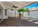 This covered patio features a brick floor, two ceiling fans, and outdoor furniture at 7632 E Bonita Dr, Scottsdale, AZ 85250