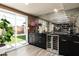Wet bar with wine cooler, mirrored backsplash and patio access to backyard area at 8341 E Hubbell St, Scottsdale, AZ 85257