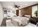Modern bedroom features a ceiling fan, decorative pillows, and sliding door closet at 8341 E Hubbell St, Scottsdale, AZ 85257