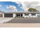 Charming single-story home with a dark-colored garage door and well-maintained landscaping in the front yard at 8341 E Hubbell St, Scottsdale, AZ 85257