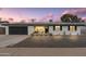 Charming single-story home with a dark-colored garage door and well-maintained landscaping in the front yard at 8341 E Hubbell St, Scottsdale, AZ 85257