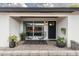 Inviting front porch with stylish seating, decorative plants, and a modern front door at 8341 E Hubbell St, Scottsdale, AZ 85257