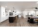 Open-concept kitchen features white cabinets, quartz countertops, stainless steel appliances, and center island with breakfast bar at 8341 E Hubbell St, Scottsdale, AZ 85257