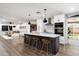 Modern kitchen with a spacious island, stylish bar stools, and seamless flow to the living area at 8341 E Hubbell St, Scottsdale, AZ 85257