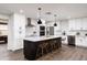 Elegant kitchen with a center island, modern appliances, white cabinets, and sleek countertops at 8341 E Hubbell St, Scottsdale, AZ 85257