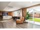 Sitting room features a modern chair, sofa, and access to a backyard with green grass at 8341 E Hubbell St, Scottsdale, AZ 85257
