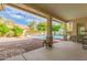 Inviting covered patio overlooking a sparkling pool and lush landscaping at 8664 W Yukon Dr, Peoria, AZ 85382