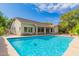 A backyard with a sparkling pool, covered patio, and lush landscaping at 8664 W Yukon Dr, Peoria, AZ 85382