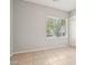 Simple bedroom with tile floors and a bright window, freshly painted and move-in ready at 8664 W Yukon Dr, Peoria, AZ 85382