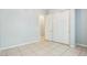 Simple bedroom with a closet, neutral walls, and tile floors at 8664 W Yukon Dr, Peoria, AZ 85382