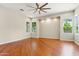 Bright bedroom featuring wood floors, recessed lighting, a modern fan, and multiple windows at 8664 W Yukon Dr, Peoria, AZ 85382