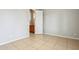 Clean, empty room with a doorway, light walls, and tile floors, ready for your personal touch at 8664 W Yukon Dr, Peoria, AZ 85382