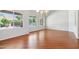 A bright dining room with wood floors, chandelier, and large windows with pool views at 8664 W Yukon Dr, Peoria, AZ 85382