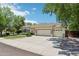 Attractive home with a spacious three-car garage and desert landscaping at 8664 W Yukon Dr, Peoria, AZ 85382