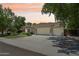 Charming single-story home featuring desert landscaping, a three-car garage, and a tile roof at 8664 W Yukon Dr, Peoria, AZ 85382