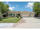 Charming single-story home featuring a well-manicured lawn and a spacious three-car garage at 8664 W Yukon Dr, Peoria, AZ 85382