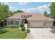 Charming single-story home featuring a well-manicured lawn and a spacious three-car garage at 8664 W Yukon Dr, Peoria, AZ 85382