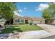 Charming single-story home showcasing a well-manicured lawn and a three-car garage at 8664 W Yukon Dr, Peoria, AZ 85382