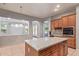 Kitchen with large center island, granite countertops, and convenient access to the living room at 8664 W Yukon Dr, Peoria, AZ 85382