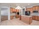Spacious kitchen with an island, stainless steel appliances, and wood cabinetry at 8664 W Yukon Dr, Peoria, AZ 85382