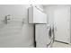Well-equipped laundry room with front-load washer, dryer, storage cabinets, and a convenient wall-mounted folding rack at 8664 W Yukon Dr, Peoria, AZ 85382