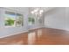 Sun-filled living room featuring hardwood floors and views of the backyard pool at 8664 W Yukon Dr, Peoria, AZ 85382