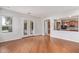 Spacious living room featuring hardwood floors and an archway leading to the kitchen at 8664 W Yukon Dr, Peoria, AZ 85382