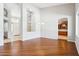 Bright living room featuring hardwood floors and an open layout to the foyer at 8664 W Yukon Dr, Peoria, AZ 85382