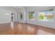 Bright and airy living room with gleaming hardwood floors and large windows at 8664 W Yukon Dr, Peoria, AZ 85382