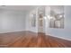 Spacious open living area with hardwood floors and neutral gray walls at 8664 W Yukon Dr, Peoria, AZ 85382