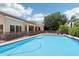 Backyard pool surrounded by mature landscaping, the property's exterior, and a safety fence at 8664 W Yukon Dr, Peoria, AZ 85382