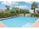 The swimming pool with crystal-clear water is surrounded by lush landscaping at 8664 W Yukon Dr, Peoria, AZ 85382