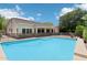 Backyard pool area with blue water and safety fence surrounded by the home's exterior at 8664 W Yukon Dr, Peoria, AZ 85382