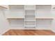 Walk-in closet features custom shelving and hardwood floors at 8664 W Yukon Dr, Peoria, AZ 85382