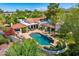Breathtaking aerial view of a home showcasing a stunning pool, outdoor living spaces, and lush landscaping at 10157 E San Salvador Dr, Scottsdale, AZ 85258