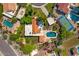 An aerial view showing pools, tennis courts, lush landscaping, and tile roofs at 10157 E San Salvador Dr, Scottsdale, AZ 85258