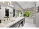 Bright bathroom with double sinks, a soaking tub, and large windows for natural light at 10157 E San Salvador Dr, Scottsdale, AZ 85258