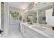 Well-lit bathroom with a marble countertop, double sinks, and a modern shower at 10157 E San Salvador Dr, Scottsdale, AZ 85258
