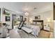 Cozy bedroom with patterned bedding, a treadmill, and a chandelier for soft lighting at 10157 E San Salvador Dr, Scottsdale, AZ 85258