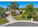 Charming home exterior with a well-manicured lawn, mature trees, and a private driveway in a desirable neighborhood at 10157 E San Salvador Dr, Scottsdale, AZ 85258