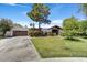 Charming single-story home featuring a well-manicured front lawn, mature landscaping, and a convenient two-car garage at 10157 E San Salvador Dr, Scottsdale, AZ 85258